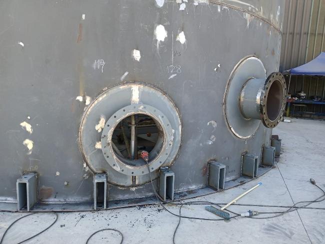 Flanged nozzles and support brackets welded to the lower shell