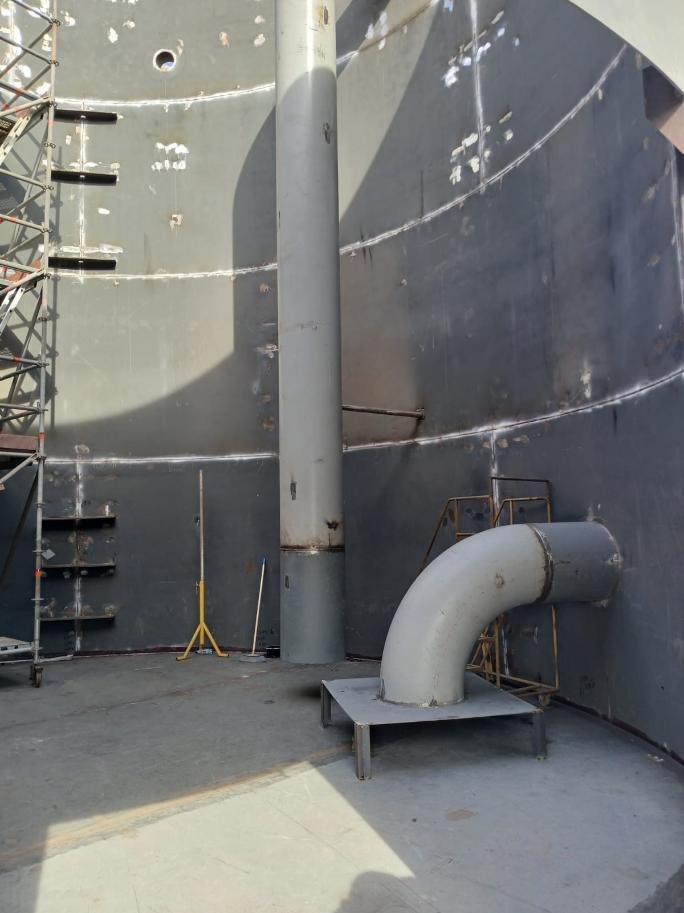 Inside the tank with the inlet pipe mounted on its base