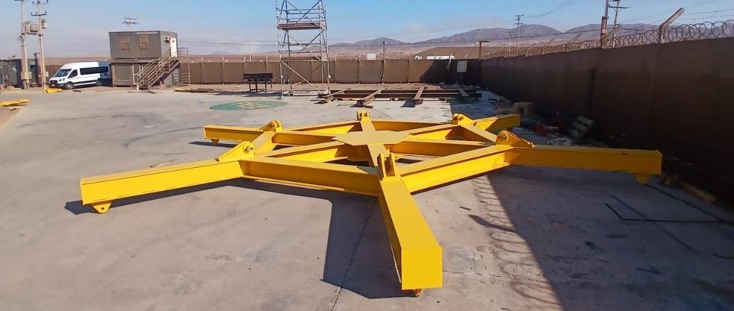 The six-arm lifting yoke painted yellow, resting in the La Negra yard